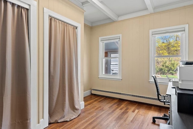 home office featuring wood finished floors, crown molding, beam ceiling, and a baseboard radiator
