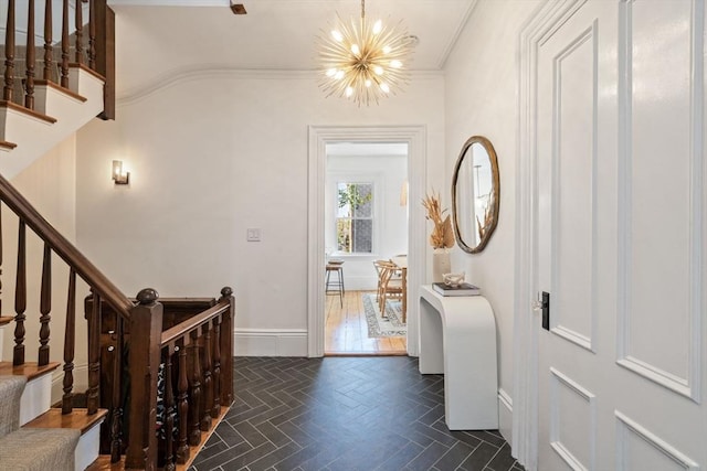 entrance foyer featuring crown molding and a notable chandelier