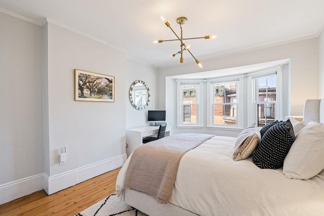 bedroom featuring hardwood / wood-style flooring, a chandelier, crown molding, and multiple windows