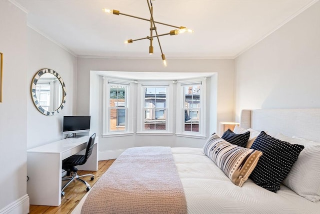 bedroom featuring crown molding, hardwood / wood-style floors, and an inviting chandelier