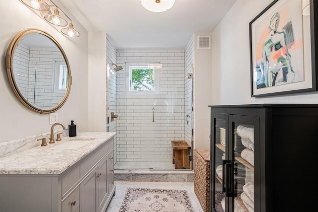 bathroom with vanity and a shower with door