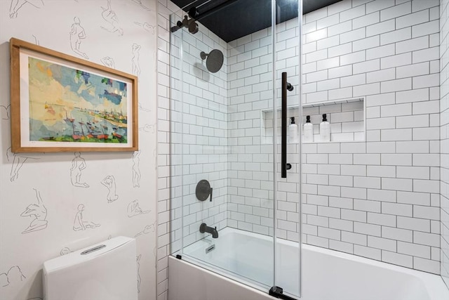 bathroom featuring toilet and combined bath / shower with glass door