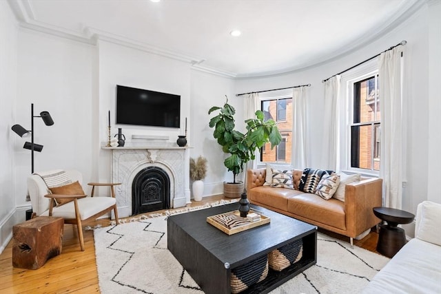 living room with wood-type flooring and ornamental molding