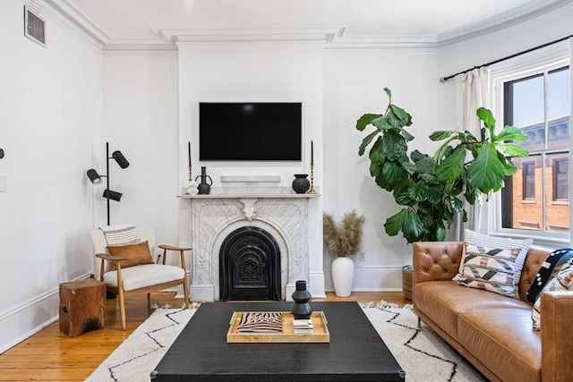 living room with crown molding and hardwood / wood-style floors