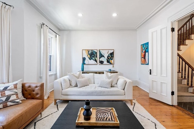 living room featuring crown molding and hardwood / wood-style flooring