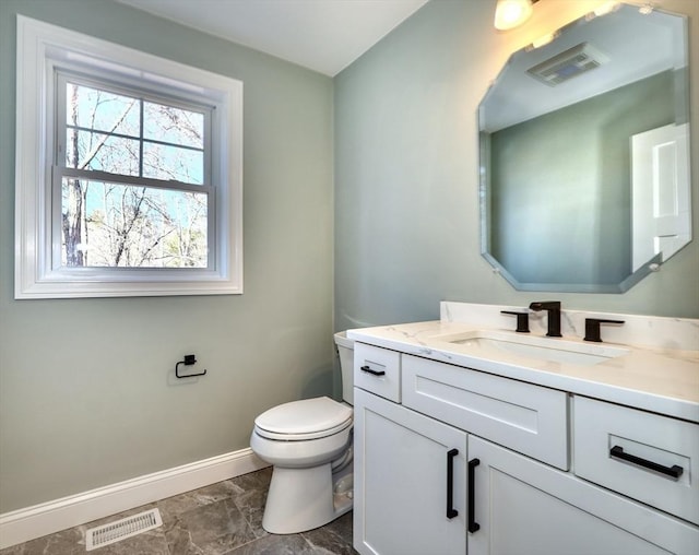 bathroom featuring vanity, toilet, baseboards, and visible vents