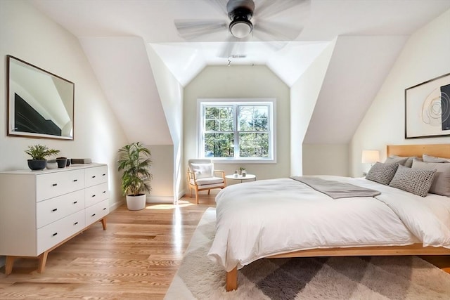 bedroom featuring light wood finished floors, a ceiling fan, and vaulted ceiling