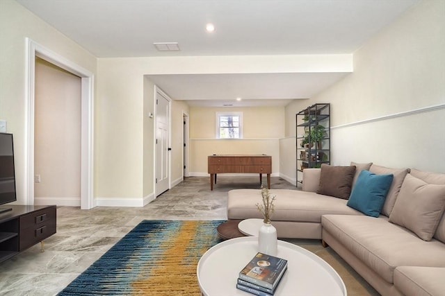 living room featuring recessed lighting and baseboards