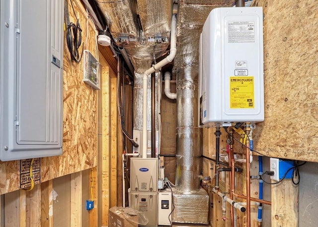 utility room featuring tankless water heater and electric panel