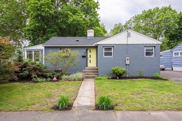 22 Sherman Ave, Northampton, MA 01060 - view of front of home with a front yard, entry steps, stucco siding, and a chimney