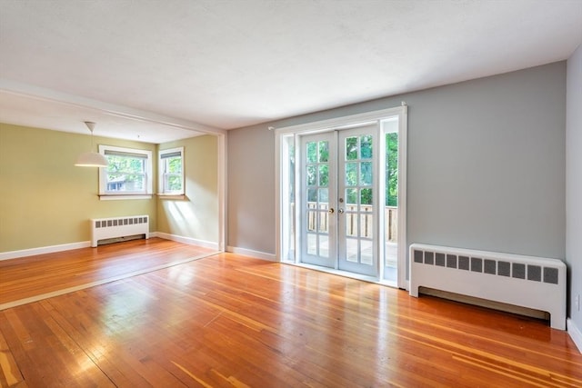 22 Sherman Ave, Northampton, MA 01060 - spare room with radiator heating unit, wood finished floors, french doors, and baseboards