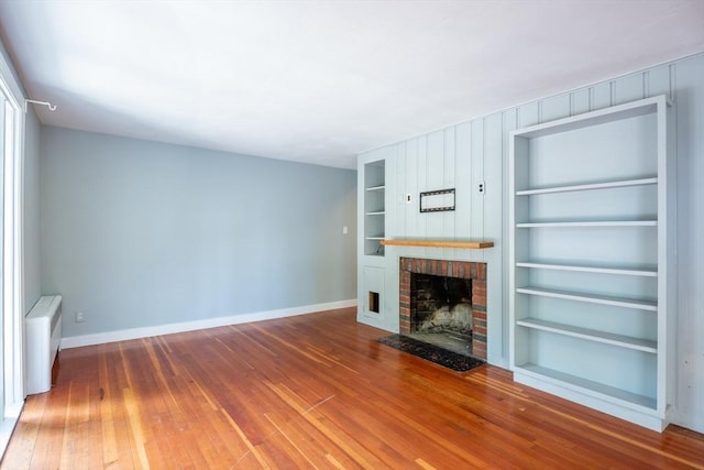 22 Sherman Ave, Northampton, MA 01060 - unfurnished living room with built in features, baseboards, a fireplace, and hardwood / wood-style floors