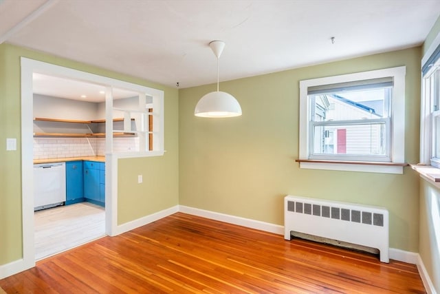22 Sherman Ave, Northampton, MA 01060 - unfurnished dining area featuring radiator, light wood-style flooring, and baseboards