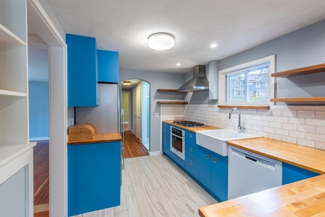 22 Sherman Ave, Northampton, MA 01060 - kitchen with open shelves, blue cabinets, wood counters, a sink, and stainless steel appliances