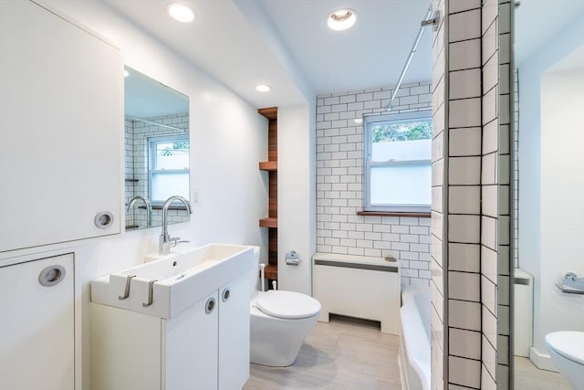 22 Sherman Ave, Northampton, MA 01060 - bathroom with toilet, a bathtub, vanity, tile walls, and recessed lighting
