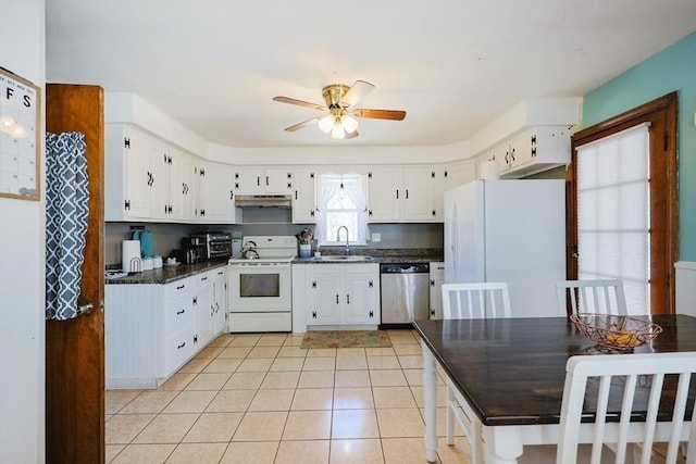 kitchen featuring white appliances, ceiling fan, under cabinet range hood, a sink, and light tile patterned floors