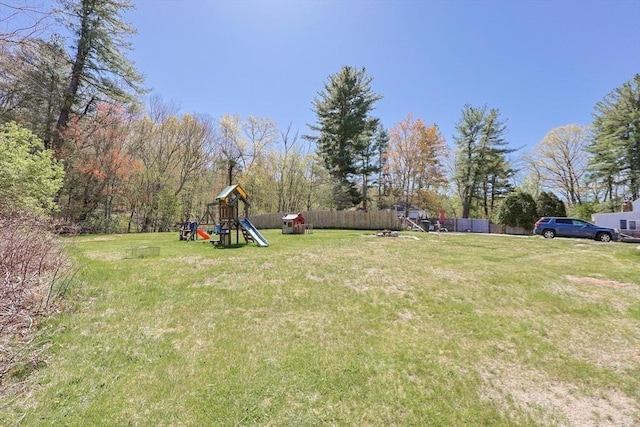 view of yard with fence and a playground