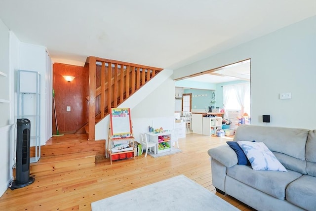 living area with wood-type flooring and stairway