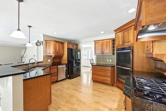 10 Tigger Ln, South Hadley, MA 01075 - kitchen with black appliances, backsplash, a textured ceiling, a peninsula, and light wood-style floors