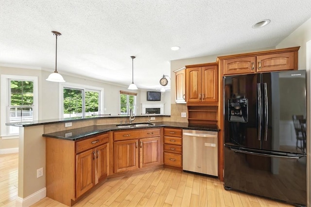 10 Tigger Ln, South Hadley, MA 01075 - kitchen featuring black fridge, dishwasher, light wood-style floors, a peninsula, and brown cabinetry