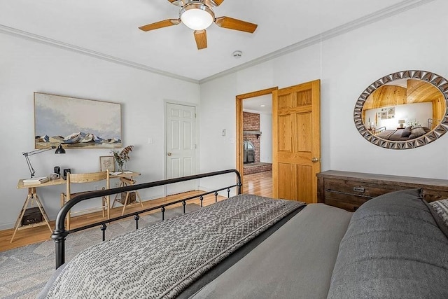 bedroom featuring hardwood / wood-style floors, crown molding, and ceiling fan