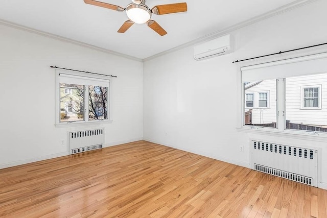 spare room with crown molding, radiator heating unit, a wall unit AC, and light wood-type flooring