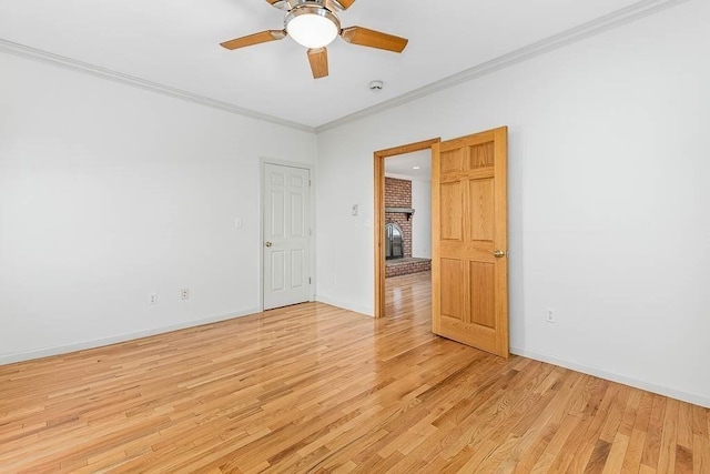 empty room with crown molding, ceiling fan, and light hardwood / wood-style floors