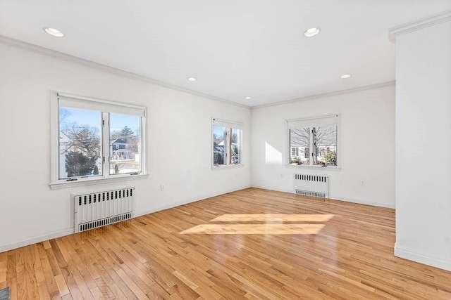 unfurnished living room featuring radiator, crown molding, and light hardwood / wood-style flooring