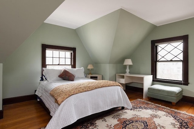 bedroom featuring vaulted ceiling, wood finished floors, and baseboards