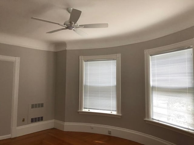 empty room featuring visible vents, baseboards, and a ceiling fan