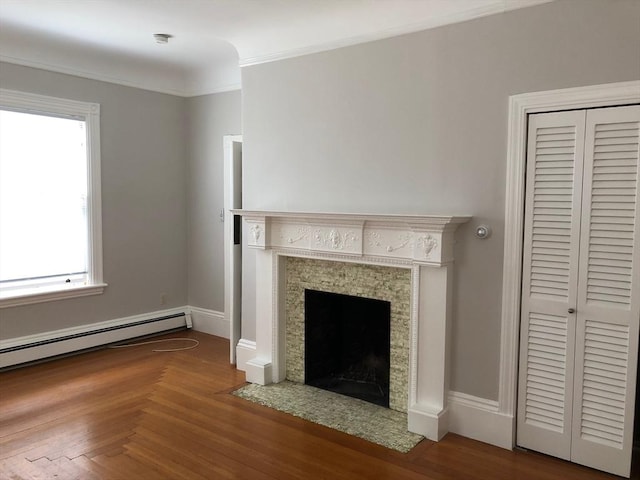 unfurnished living room featuring a baseboard heating unit, ornamental molding, and a tiled fireplace
