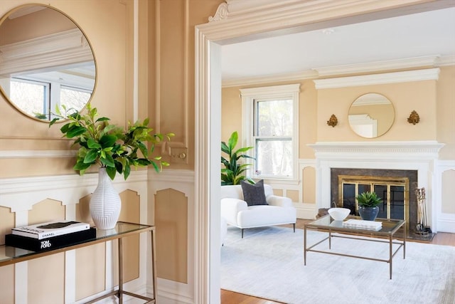 87 Crowninshield Rd, Brookline, MA 02446 - living area with crown molding, wood finished floors, and a fireplace