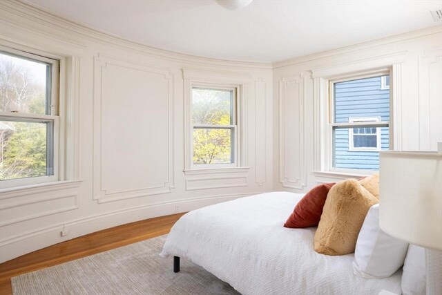 87 Crowninshield Rd, Brookline, MA 02446 - bedroom with ornamental molding, wood finished floors, and multiple windows
