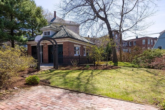 87 Crowninshield Rd, Brookline, MA 02446 - view of front facade featuring a front yard and brick siding
