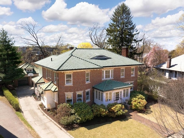 87 Crowninshield Rd, Brookline, MA 02446 - exterior space featuring brick siding, driveway, a chimney, and a tile roof