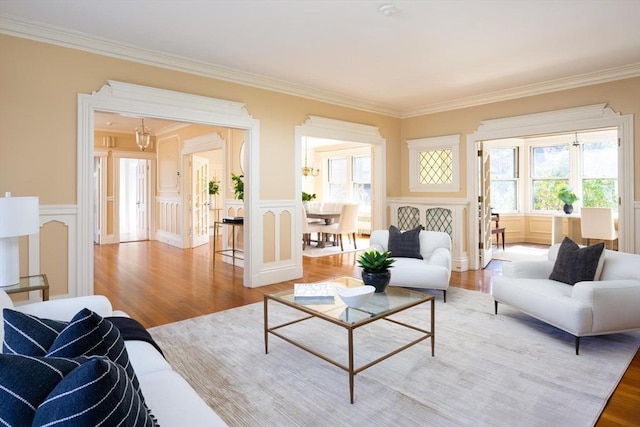 87 Crowninshield Rd, Brookline, MA 02446 - living area with crown molding, a decorative wall, and light wood-type flooring