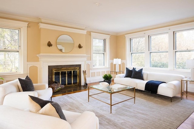 87 Crowninshield Rd, Brookline, MA 02446 - living area featuring crown molding, a wainscoted wall, wood finished floors, and a decorative wall