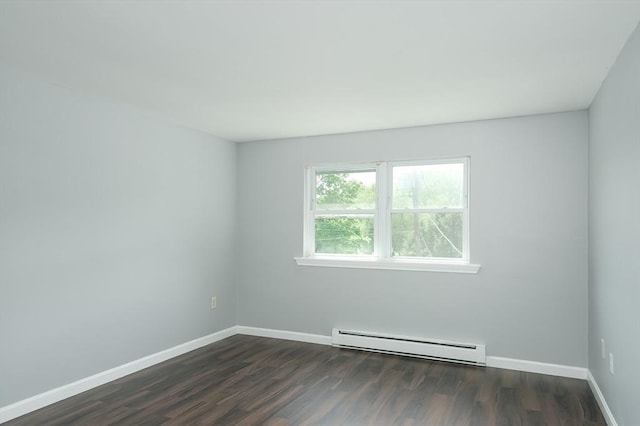unfurnished room featuring a baseboard heating unit, dark wood-style flooring, and baseboards