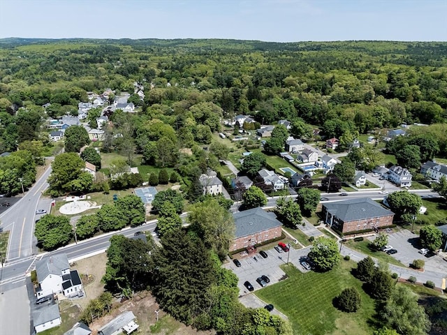 aerial view of property and surrounding area with a heavily wooded area