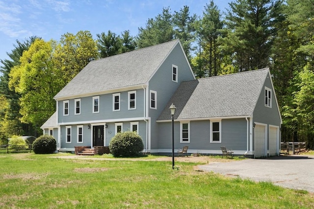 94 Old Right Rd, Ipswich, MA 01938 - colonial house featuring asphalt driveway, a front yard, a shingled roof, and a garage
