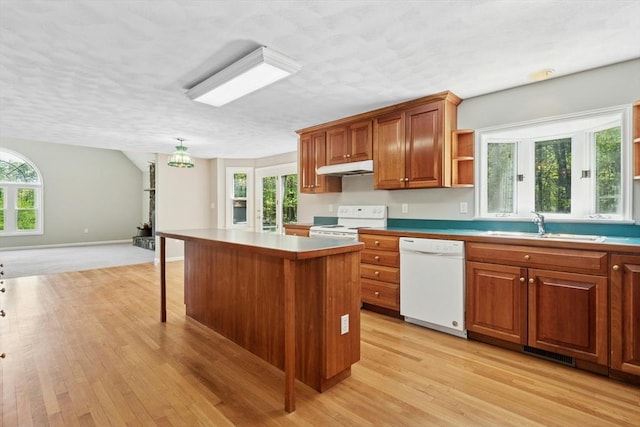 94 Old Right Rd, Ipswich, MA 01938 - kitchen featuring white appliances, under cabinet range hood, light wood-style flooring, a textured ceiling, and plenty of natural light