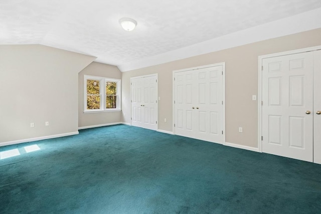 94 Old Right Rd, Ipswich, MA 01938 - unfurnished bedroom with two closets, lofted ceiling, dark carpet, and a textured ceiling