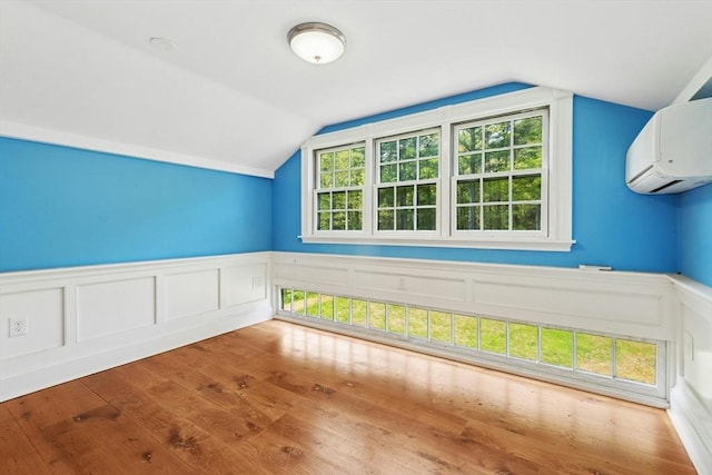 94 Old Right Rd, Ipswich, MA 01938 - bonus room featuring a wall unit AC, lofted ceiling, wood finished floors, a wainscoted wall, and a decorative wall