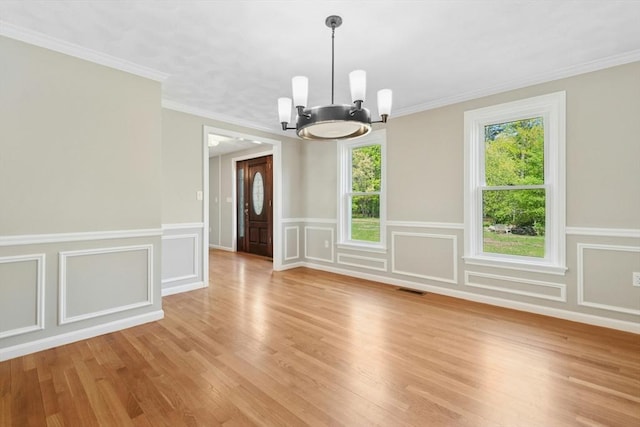 94 Old Right Rd, Ipswich, MA 01938 - unfurnished dining area featuring a chandelier, light wood-type flooring, a wainscoted wall, a decorative wall, and ornamental molding