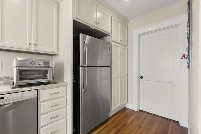 16 Field Rd Unit 16, Arlington, MA 02476 - kitchen with appliances with stainless steel finishes, dark wood-type flooring, white cabinetry, and light stone counters