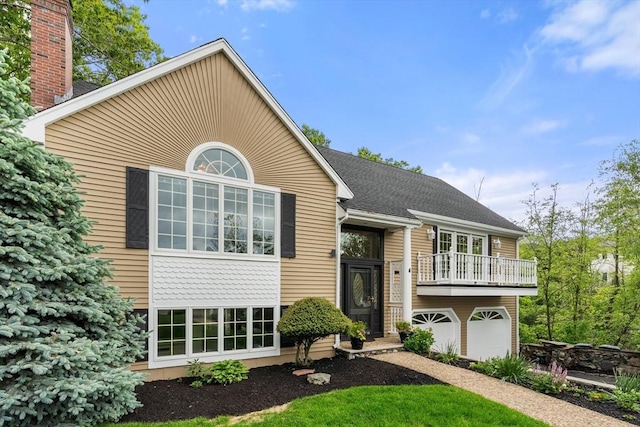 4 Blacksmith Way, Saugus, MA 01906 - split foyer home featuring a balcony, a garage, and roof with shingles