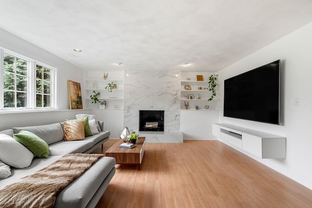 4 Blacksmith Way, Saugus, MA 01906 - living room with wood finished floors, built in features, and a high end fireplace