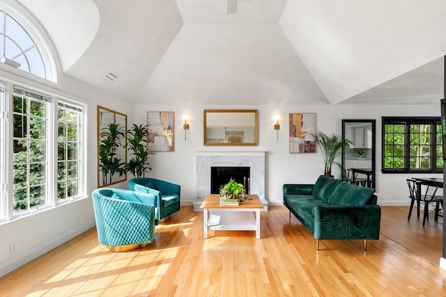 4 Blacksmith Way, Saugus, MA 01906 - living room with high vaulted ceiling, healthy amount of natural light, a premium fireplace, wood finished floors, and baseboards