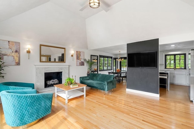 4 Blacksmith Way, Saugus, MA 01906 - living room with light wood finished floors, a premium fireplace, ceiling fan, high vaulted ceiling, and a chandelier