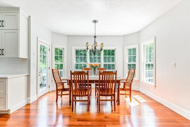 138 Saddleworth Way, Middleboro, MA 02346 - dining room with a chandelier, light wood-style floors, and baseboards
